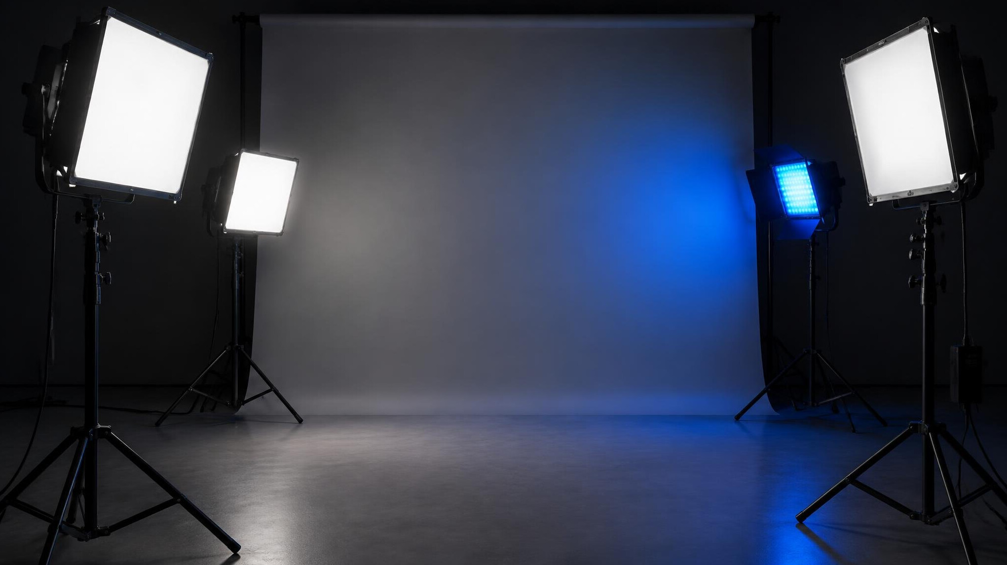 Lighting panels and a diffusion screen on stands in a studio